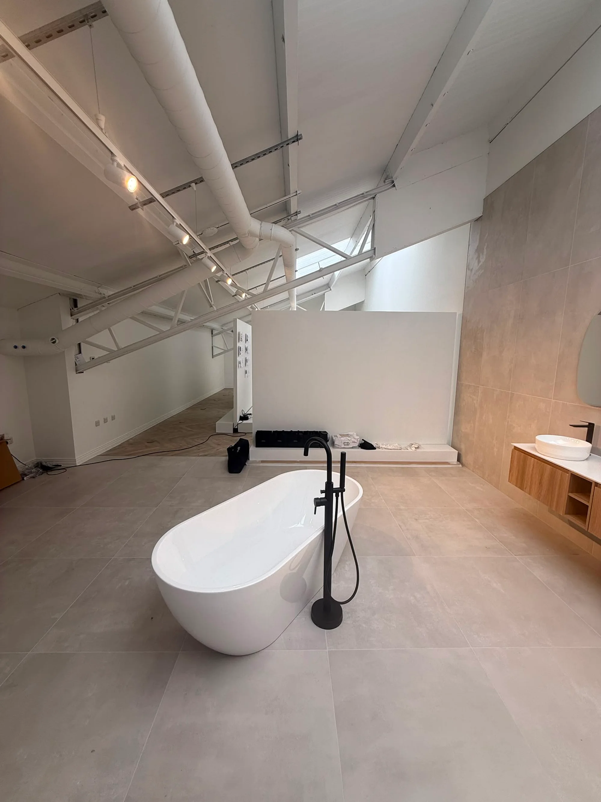 Finished bathroom scene with freestanding bath and vanity