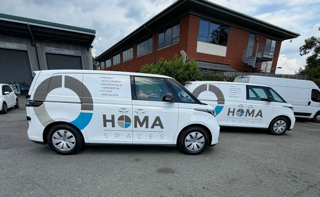 HOMA Spaces liveried vans parked on site